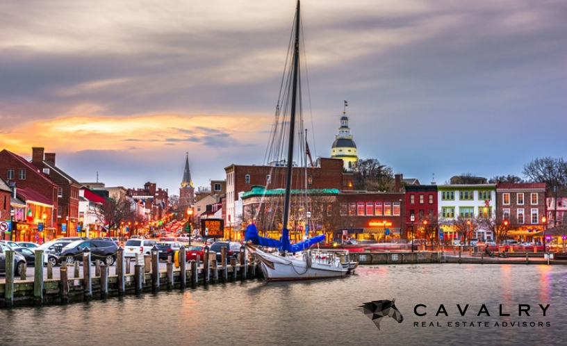 Annapolis, Maryland, at dusk with Cavalry Real Estate Advisors Logo