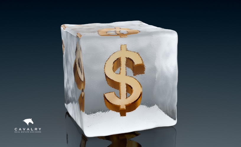 Image showing a dollar sign frozen in an ice cube to represent a tax freeze